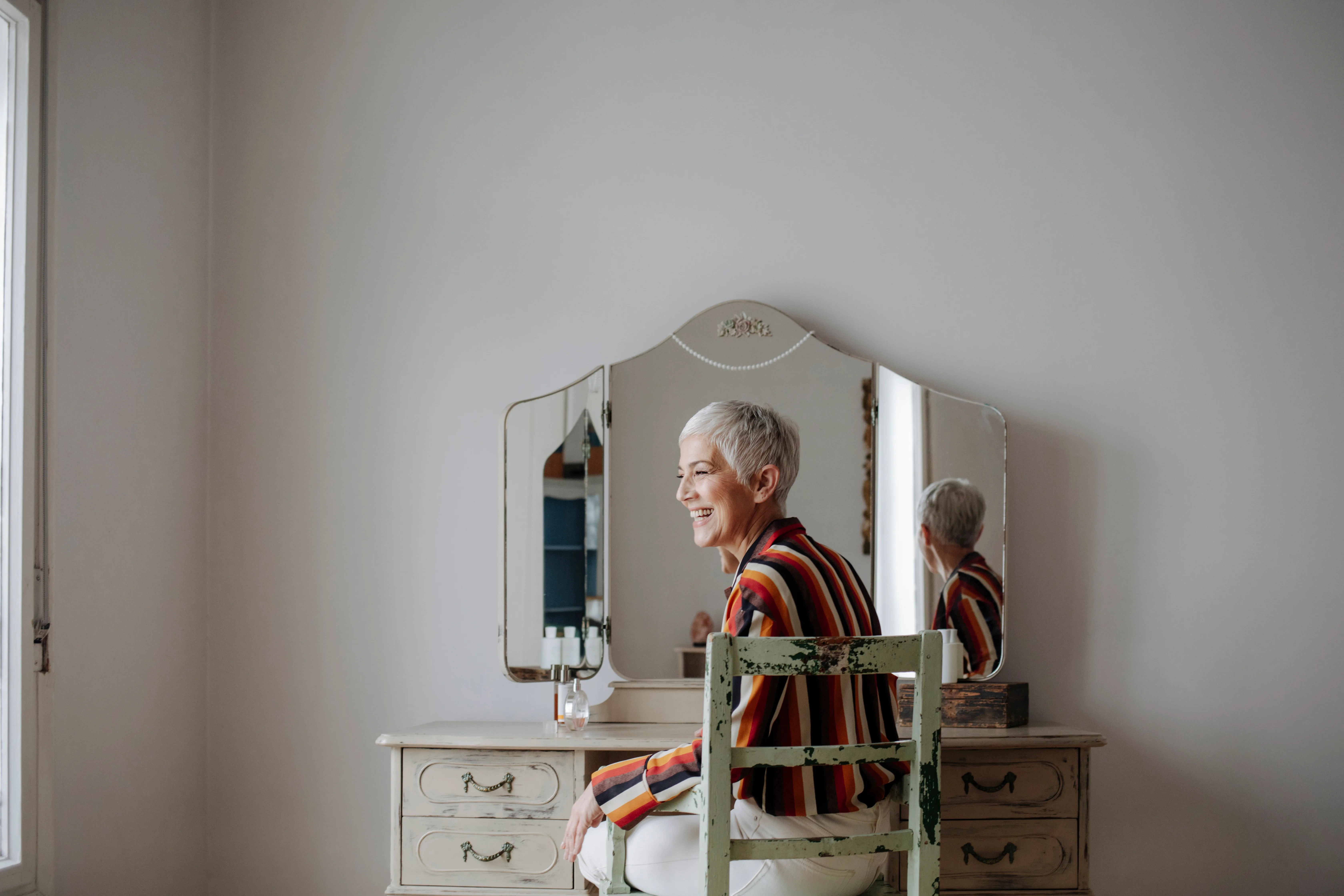 lady with white hair sitting at dressing table