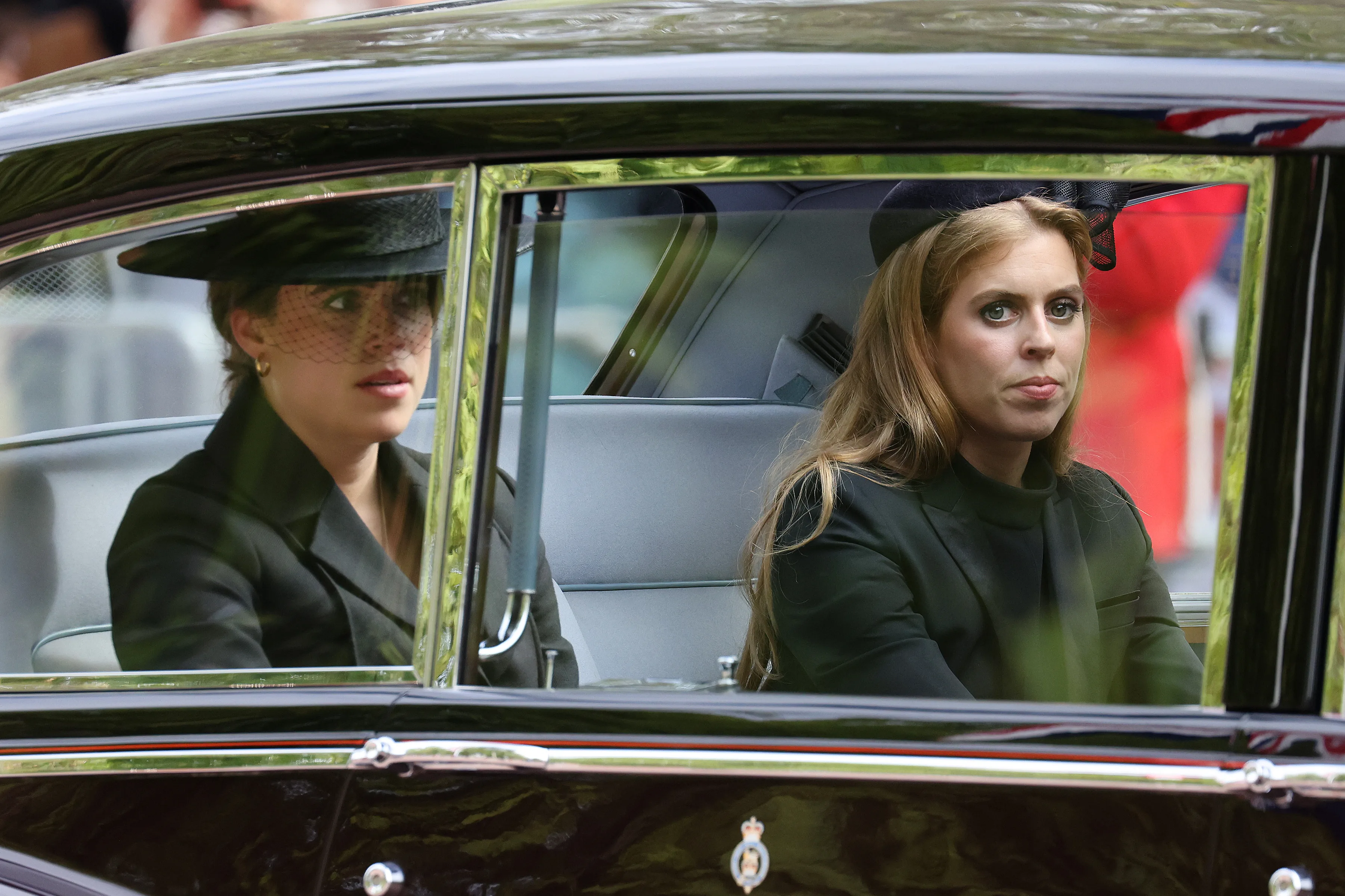 Princess Eugenie and Princess Beatrice leaving their grandmother's funeral in a car. 