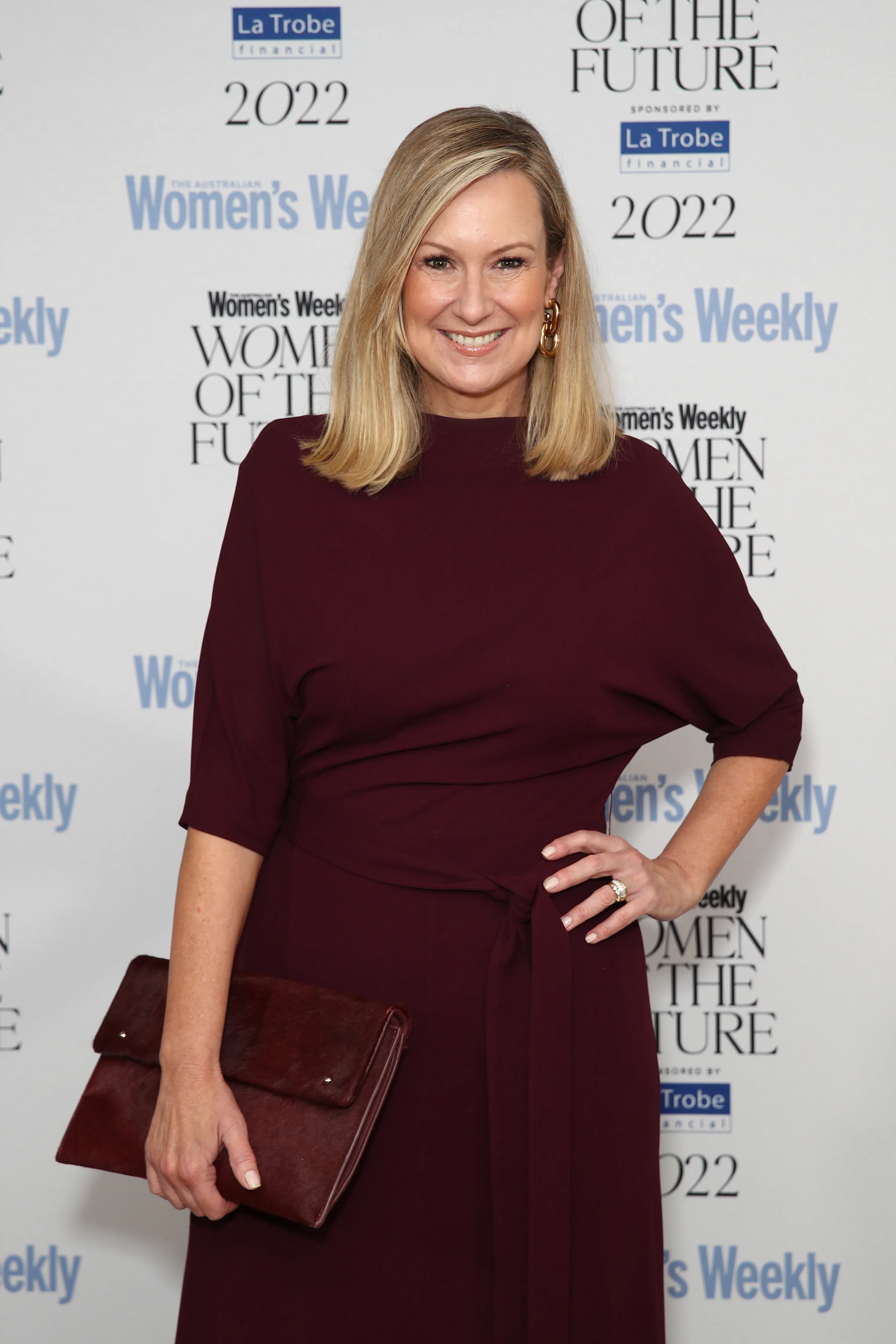 Melissa Doyle burgundy dress and purse at the women of the future awards 2022.