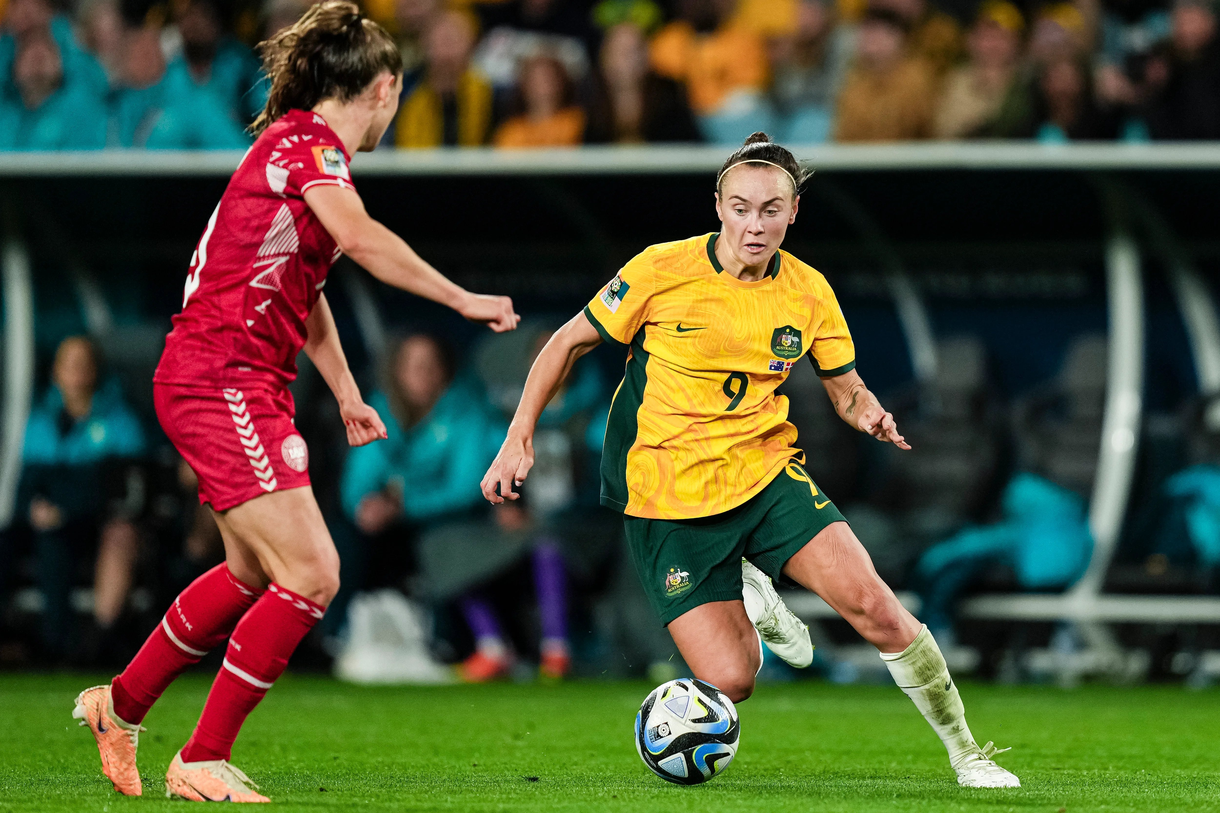 Caitlin Foord of Australia dribbles Janni Thomsen of Denmark during the 2023 FIFA Women's World Cup.