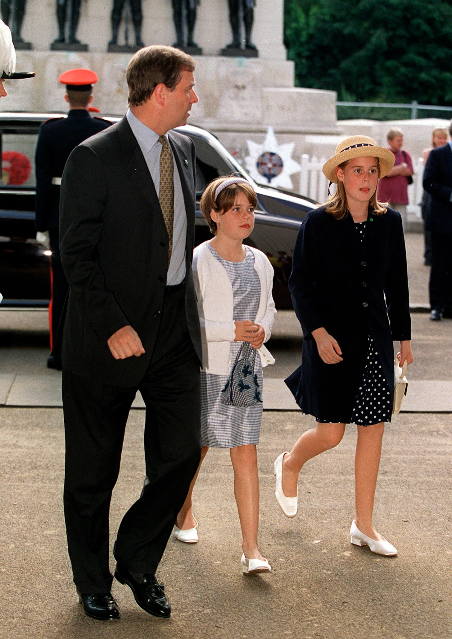 Britain's Prince Andrew w. daughters Princess Eugenie and Princess Beatrice arriving at pageant honoring the 100th birthday of Queen Elizabeth.