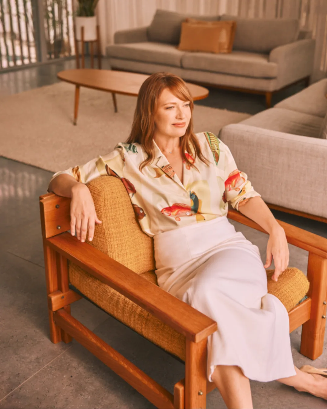 The Fringe actress sitting on a chair.