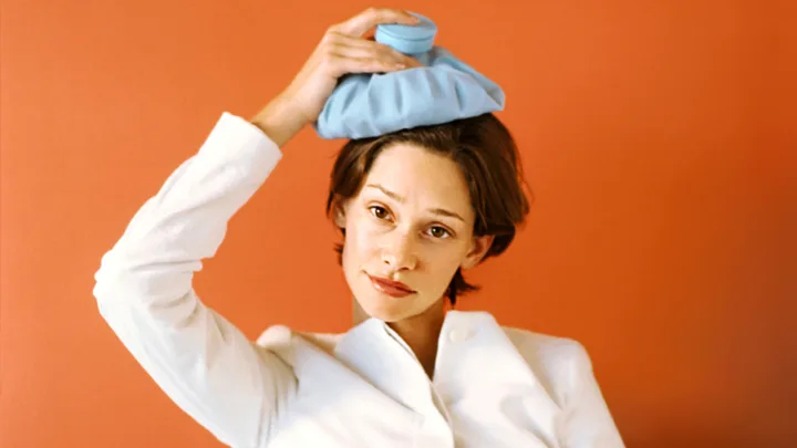 woman holding ice pack to her head