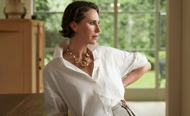 Woman in white shirt and gold necklace