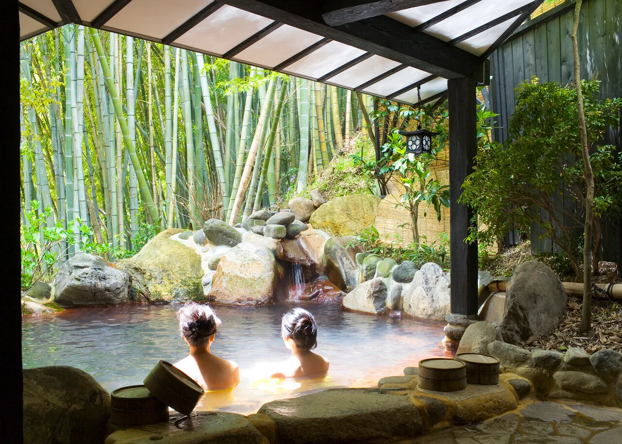 Women bathing in an outdoor pool (rotemburo) at Yumotoso - a hot spring resort in Kurokawa Onsen.