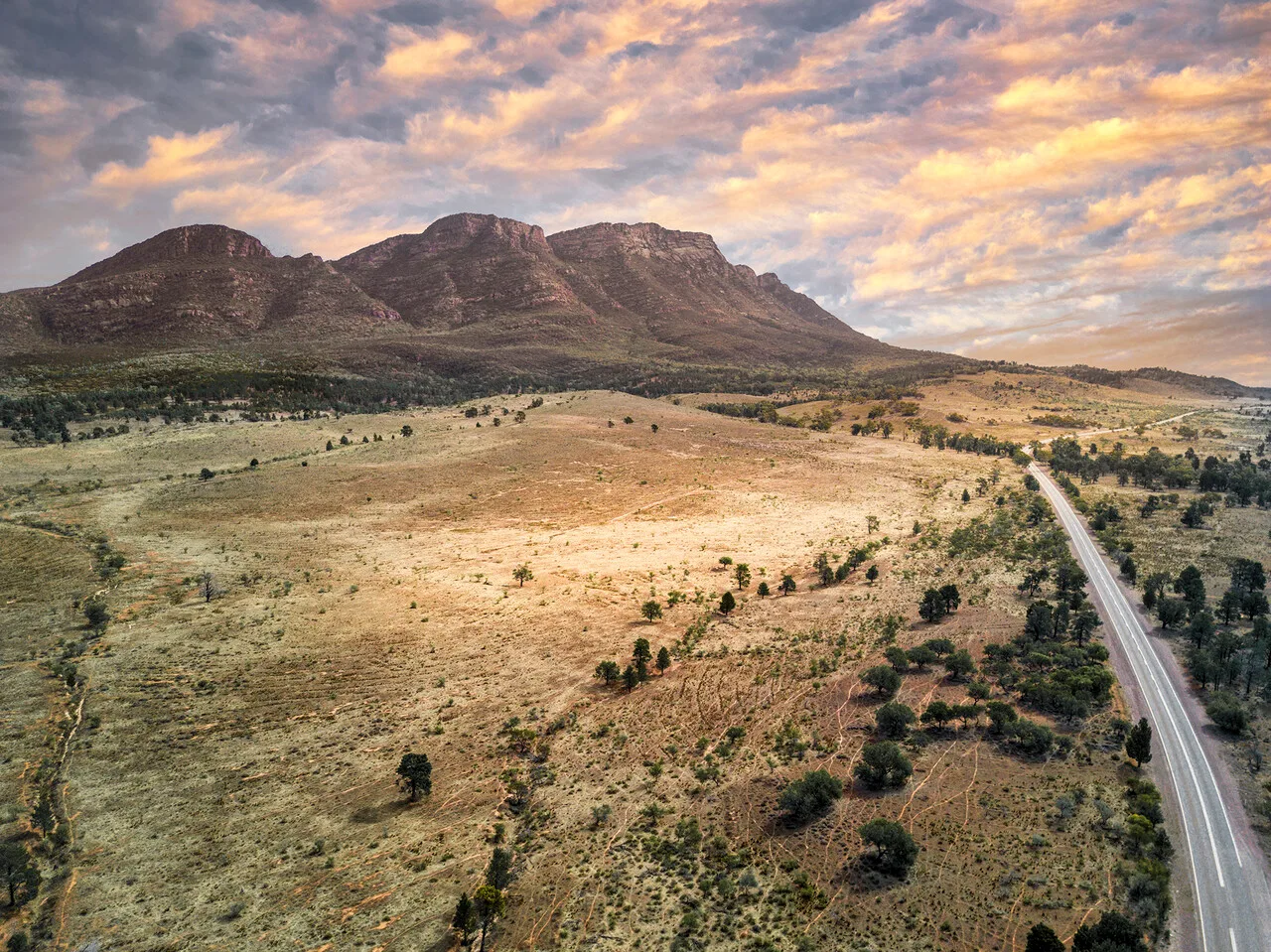 Outback view of Wilpena Pound from a drone showing the peak and road