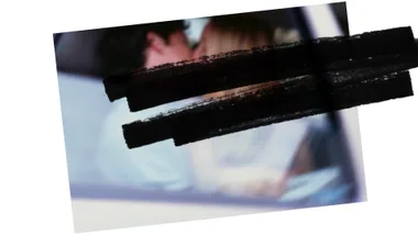 A blurred photo showing two people kissing in a car, obscured by black lines.