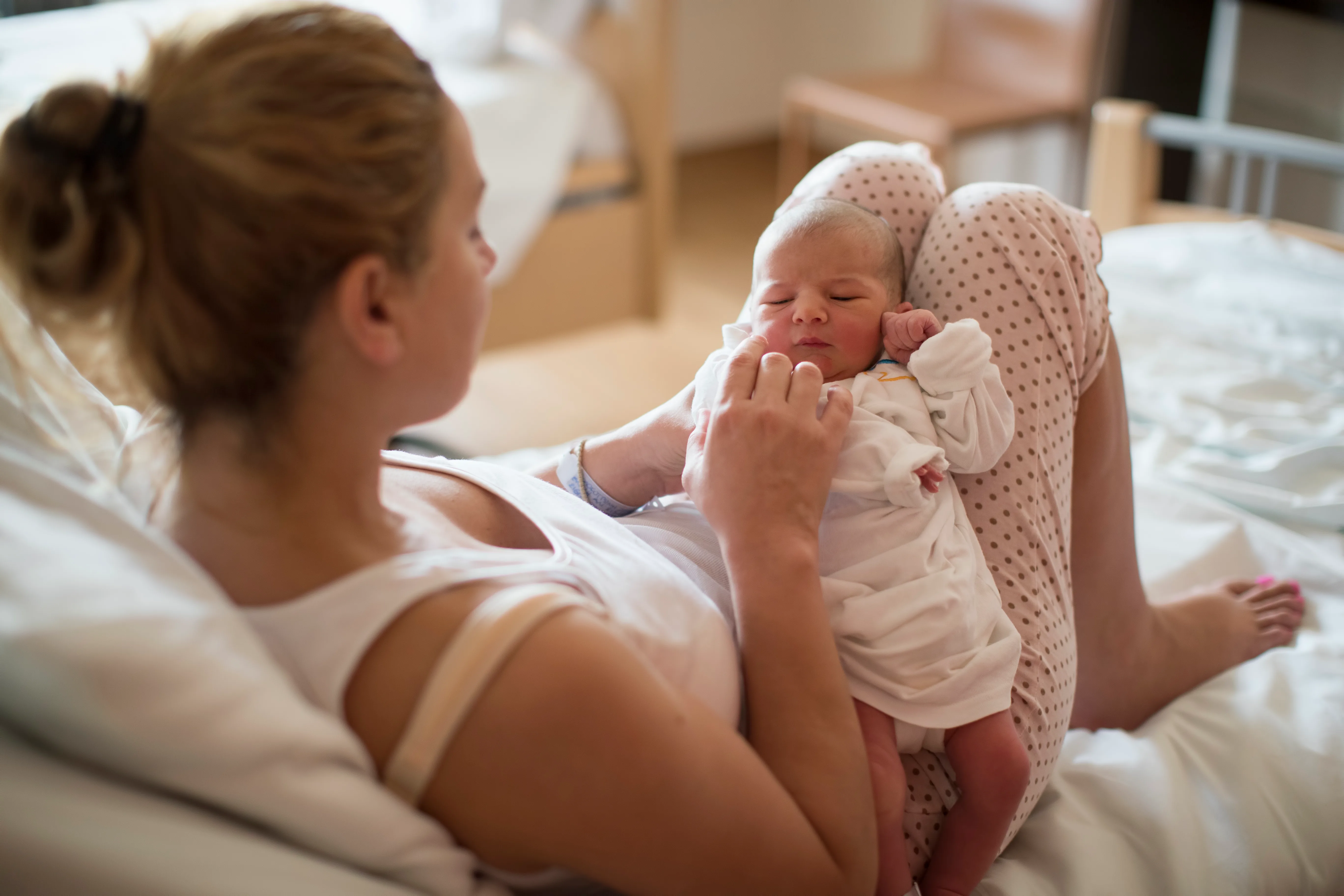 women with newborn baby in hospital.