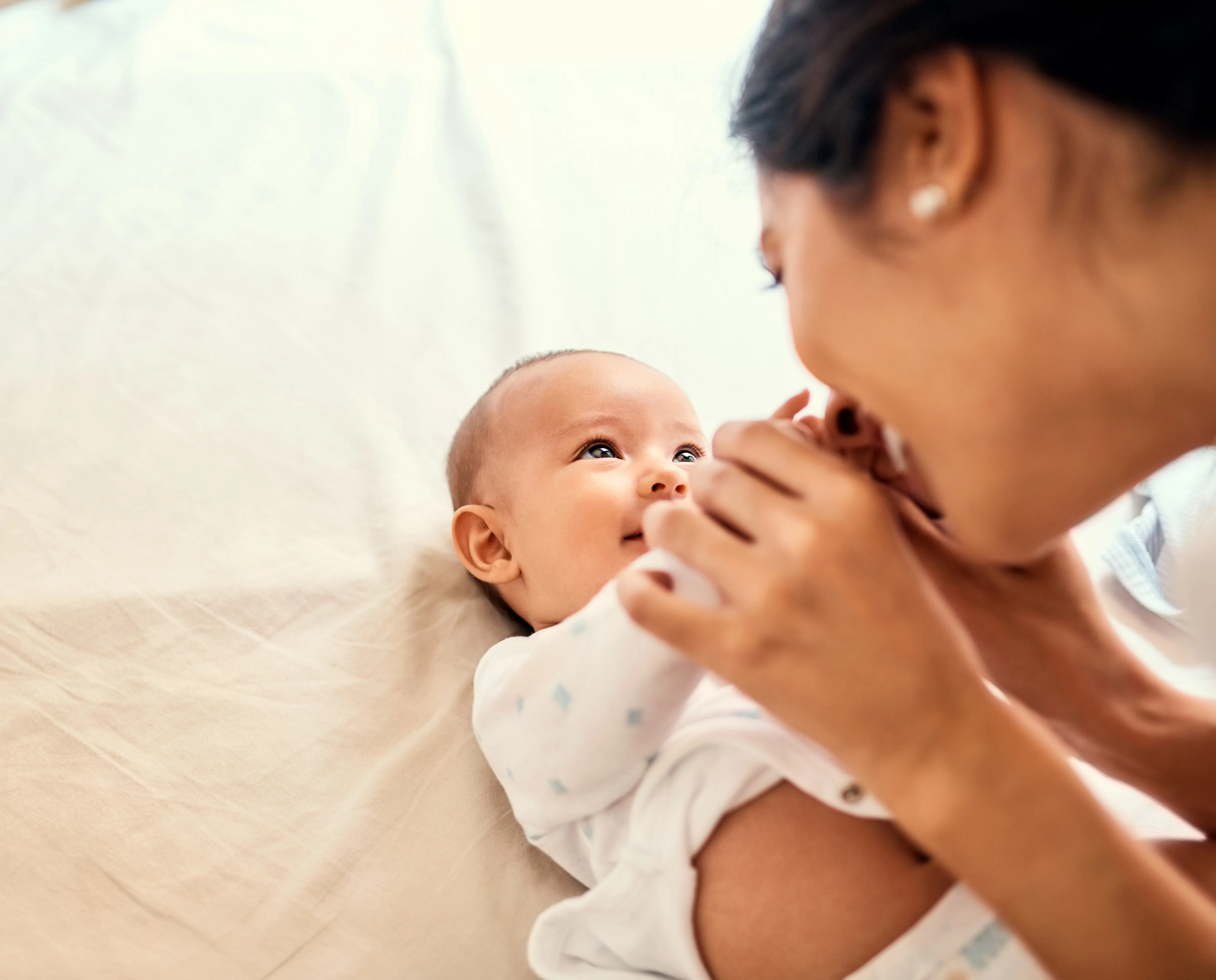 Shot of a happy mother bonding with her baby boy at home