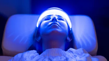 Woman having LED facial treatment