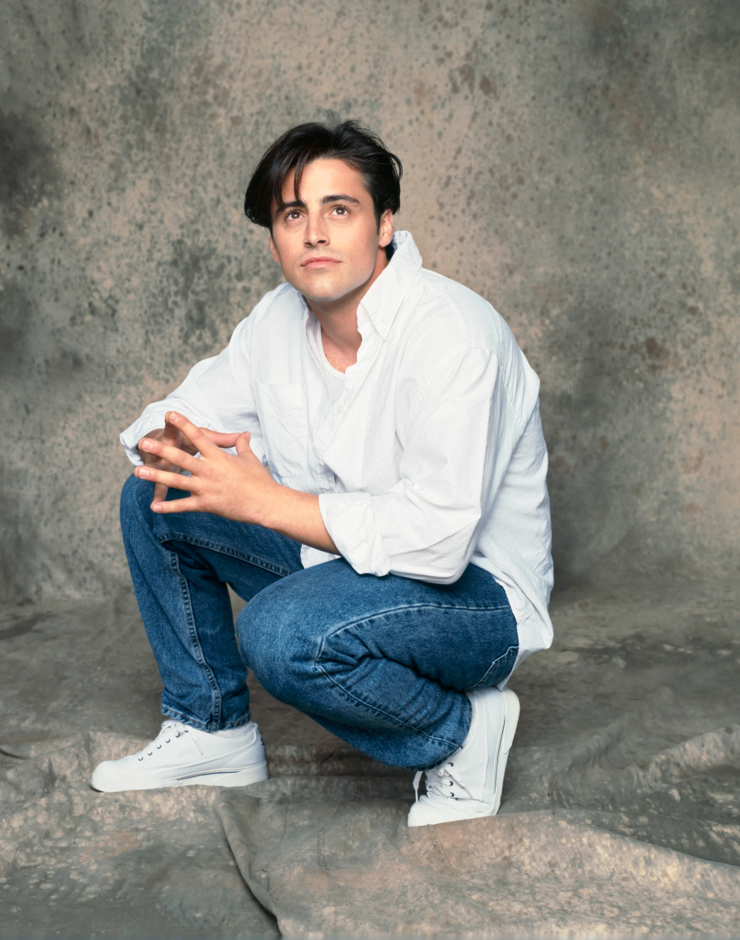 Matt LeBlanc wears a white button shirt and jeans for a Friends promo shoot