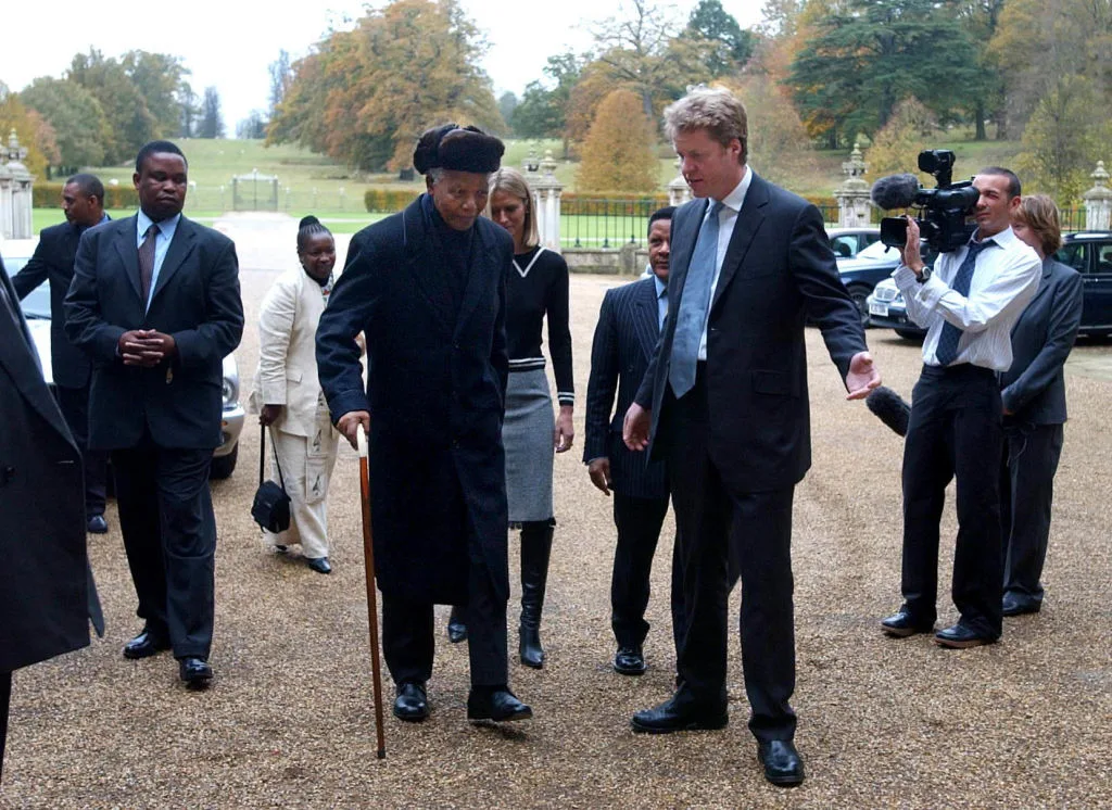 Former South African president Nelson Mandela arrives at Althorp, Northamptonshire on a visit to the grave of Diana, Princess of Wales, and meets her brother Earl Spencer (centre right). * Mr Mandela, 84, was planting a tree in the grounds of the estate and laying a wreath at the island burial site during the visit, when he also discussed a new charity project with Earl Spencer. (Photo by David Jones - PA Images/PA Images via Getty Images)