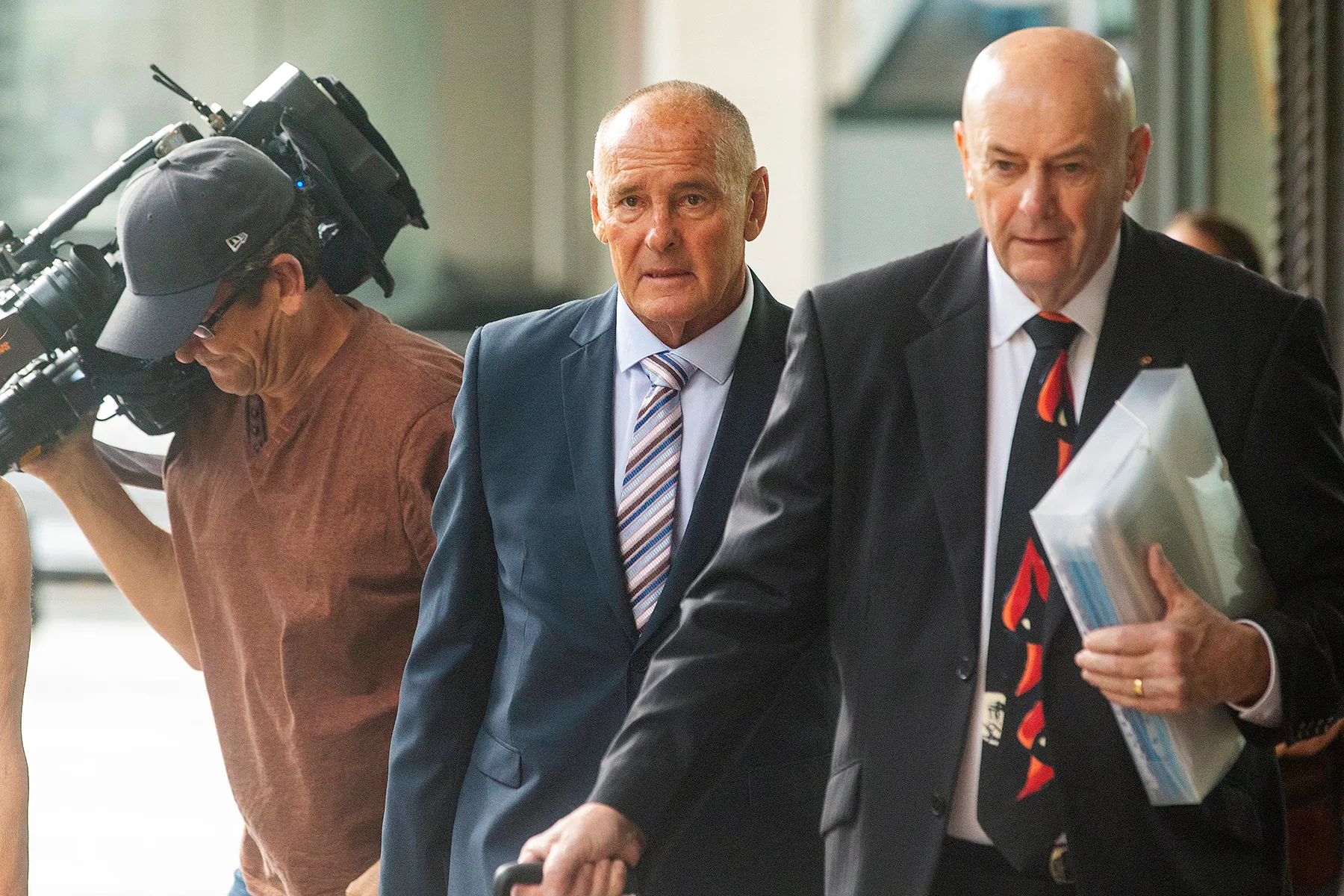 SYDNEY, AUSTRALIA - FEBRUARY 10: Chris Dawson (C) arrives at Downing Centre Local Court on February 10, 2020 in Sydney, Australia. Chris Dawson has been charged with murder over the disappearance of his wife Lynette Dawson in 1982.  (Photo by Jenny Evans/Getty Images)