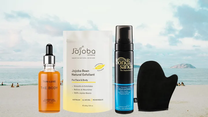 Self-tanning products with a beach background: Tan-Luxe Drops, Jojoba Exfoliant, Bondi Sands Foam, and mitt.