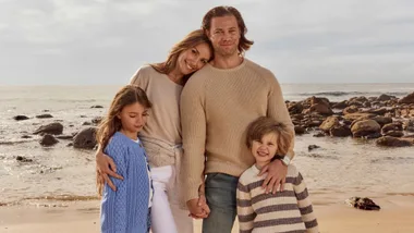 Rachael Finch with husband Michael and children Dom and Violet on the beach in Sydney