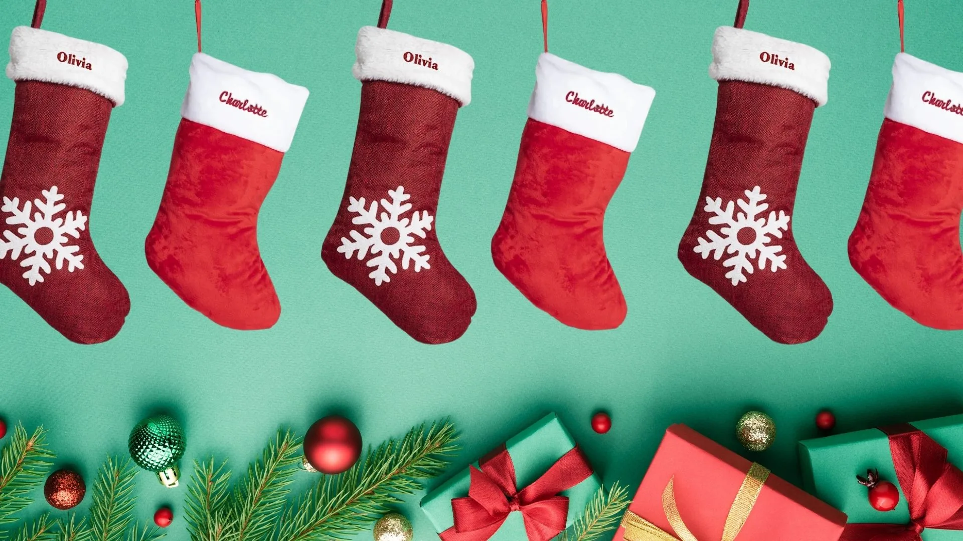 Red Christmas stockings labeled "Olivia" and "Charlotte" hang above gifts and ornaments on a green background.