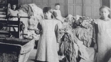 Children working in a textile factory, handling fabrics and machinery, dressed in aprons, early 20th century.