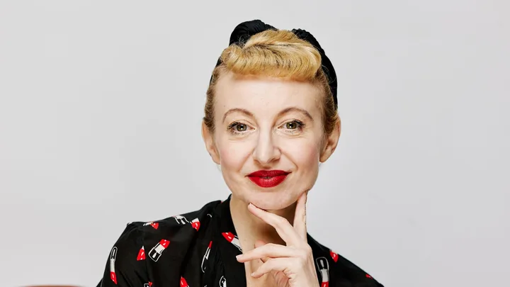 Poppy King wearing red lipstick