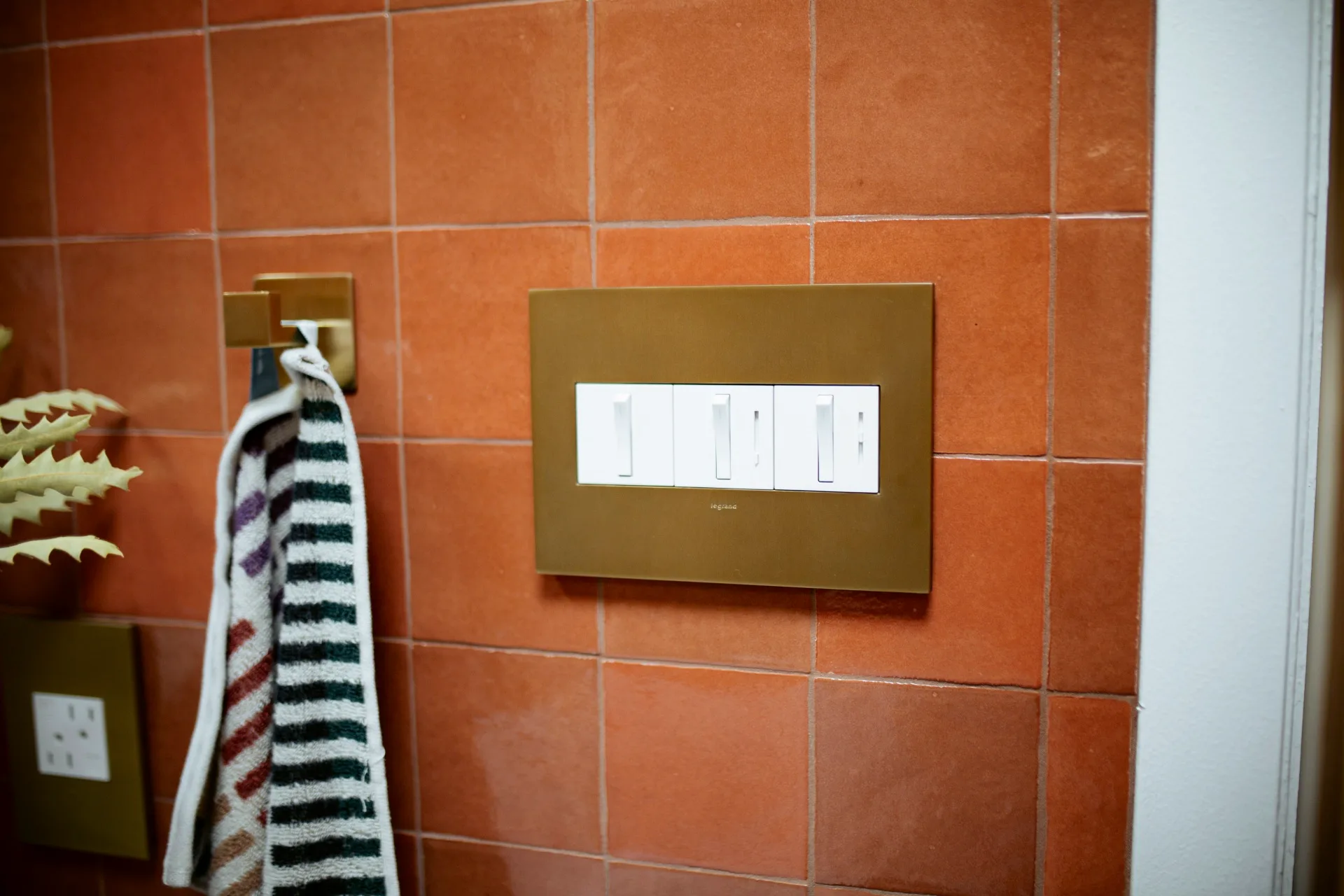 Light switch plate on a tiled wall easy home makeover tips