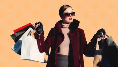 A fashionable woman in sunglasses holds multiple shopping bags against a patterned orange background.