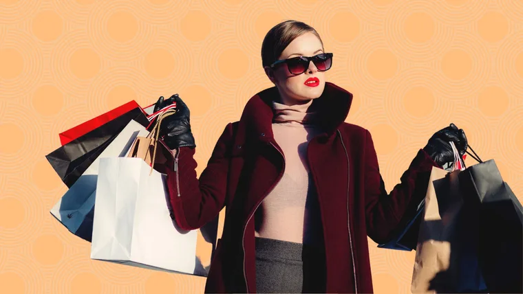 A fashionable woman in sunglasses holds multiple shopping bags against a patterned orange background.