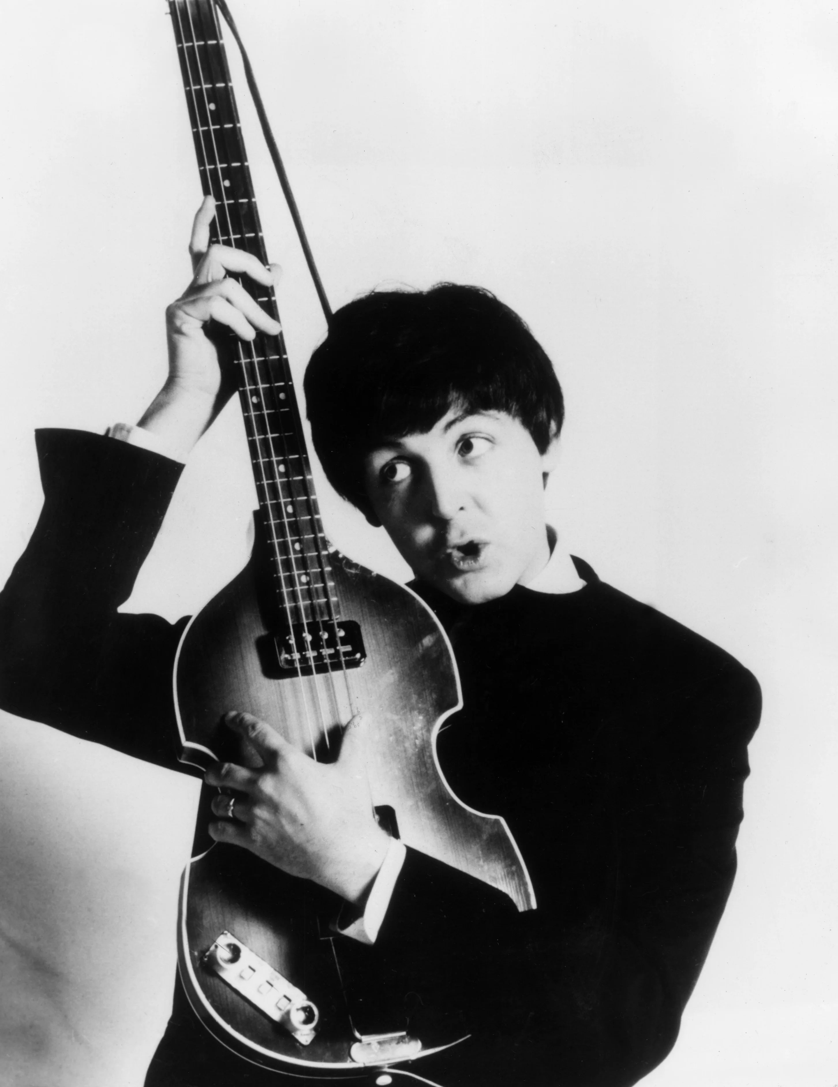 circa 1965: Paul McCartney of The Beatles with his Hohner bass. (Photo by Express/Express/Getty Images)