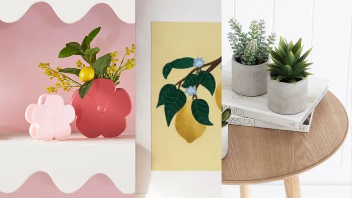 Decorative flower pots, lemon artwork, and potted succulents on a wooden table with books, creating cozy decor.