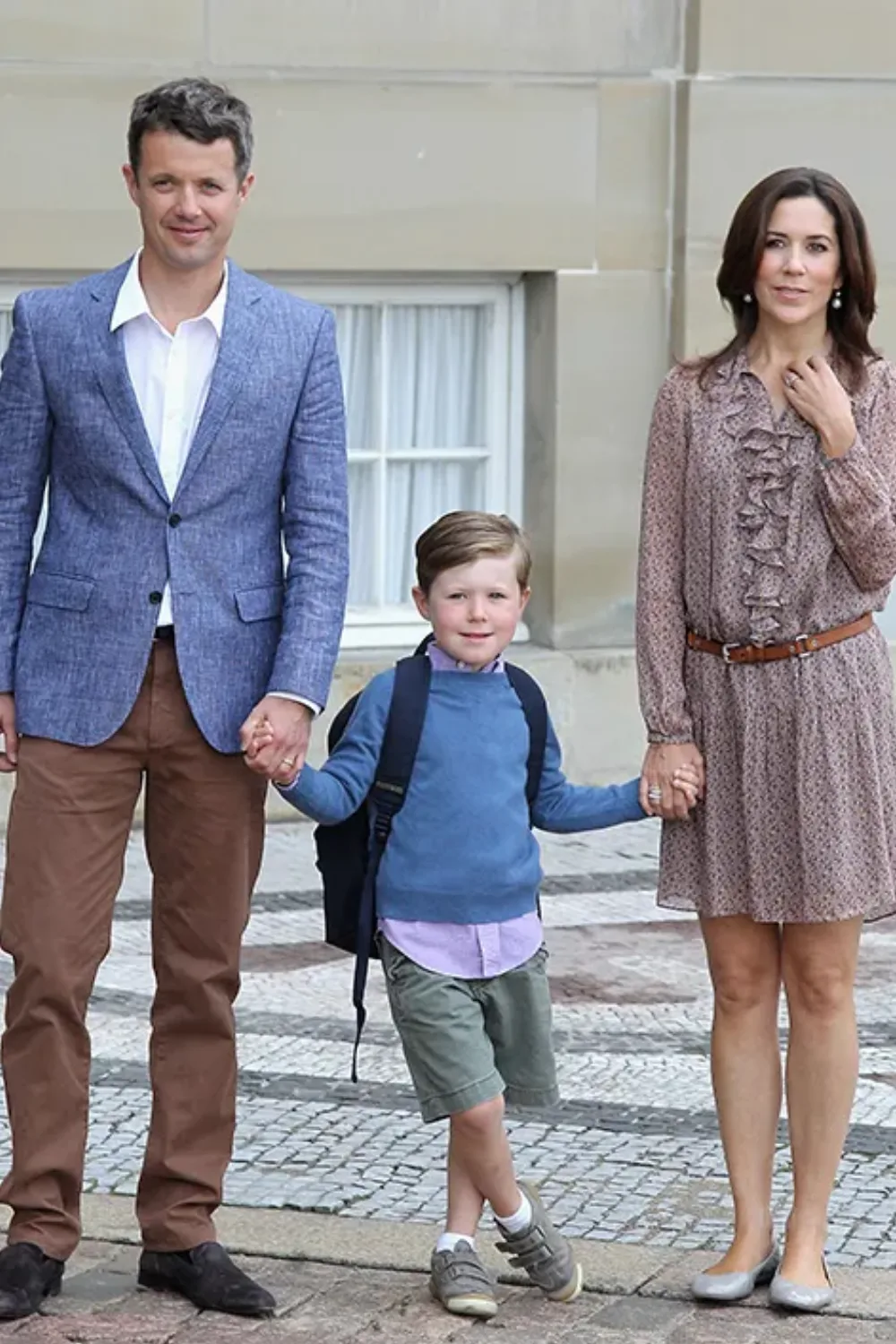 King Frederik, Prince Christian, and Queen Mary hold hands