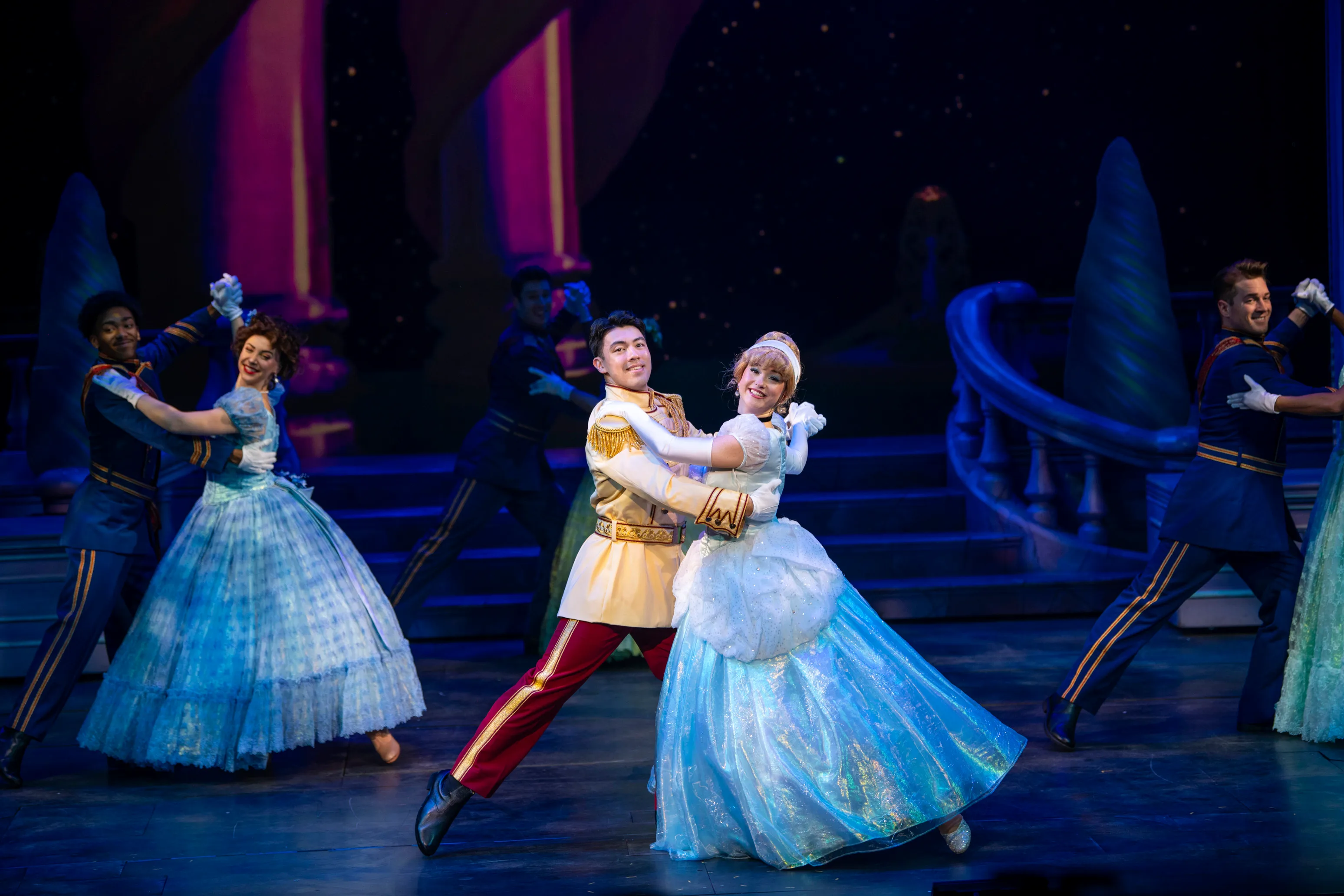 Cinderella and the prince dancing during a stage show.