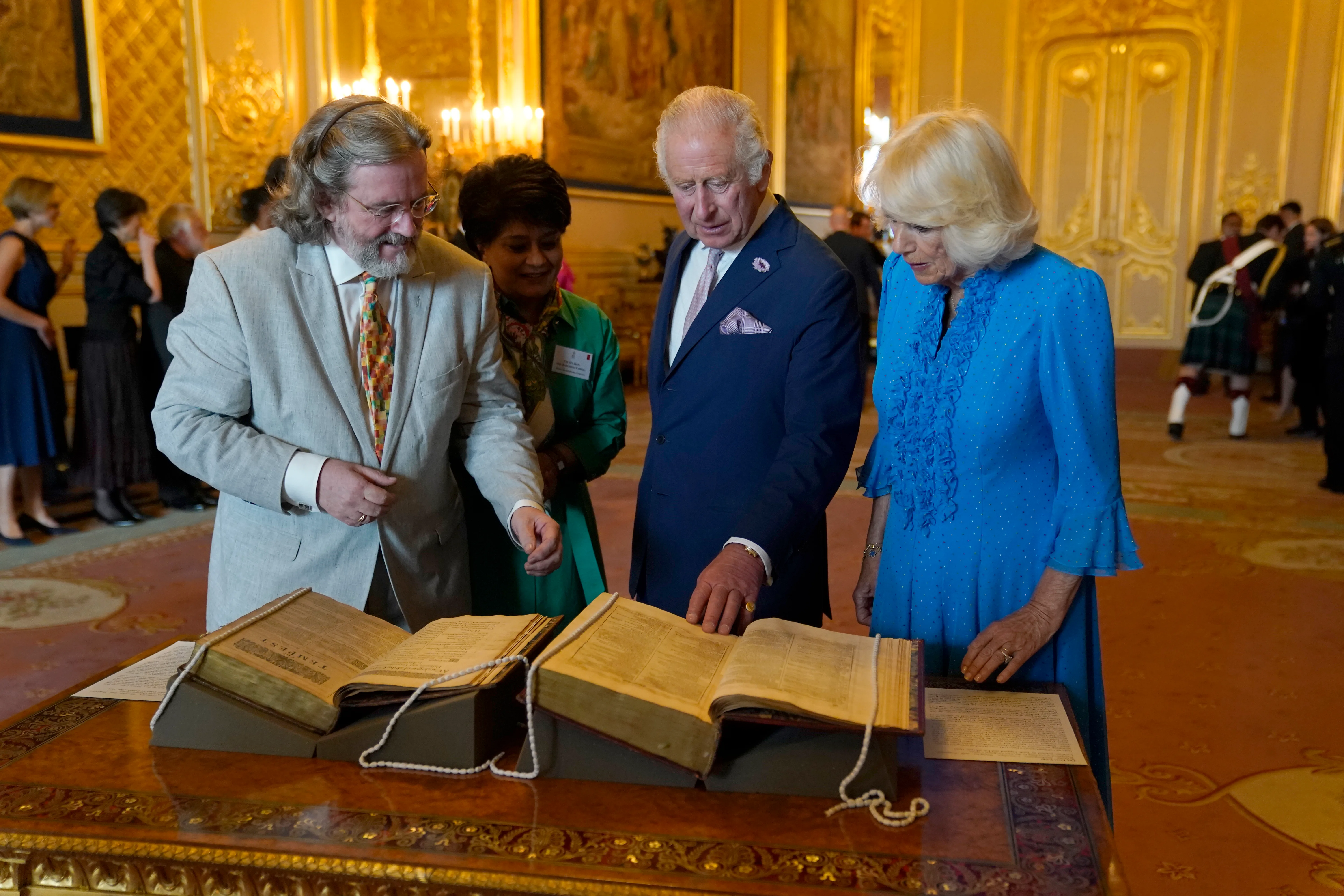 WINDSOR, ENGLAND - JULY 18: King Charles III and Queen Camilla observe the second Shakespeare Folio during a reception to celebrate the work of William Shakespeare on the 400th anniversary of the publication of the first Shakespeare Folio at Windsor Castle on July 18, 2023 in Windsor, England. (Photo by Andrew Matthews - Pool / Getty Images)