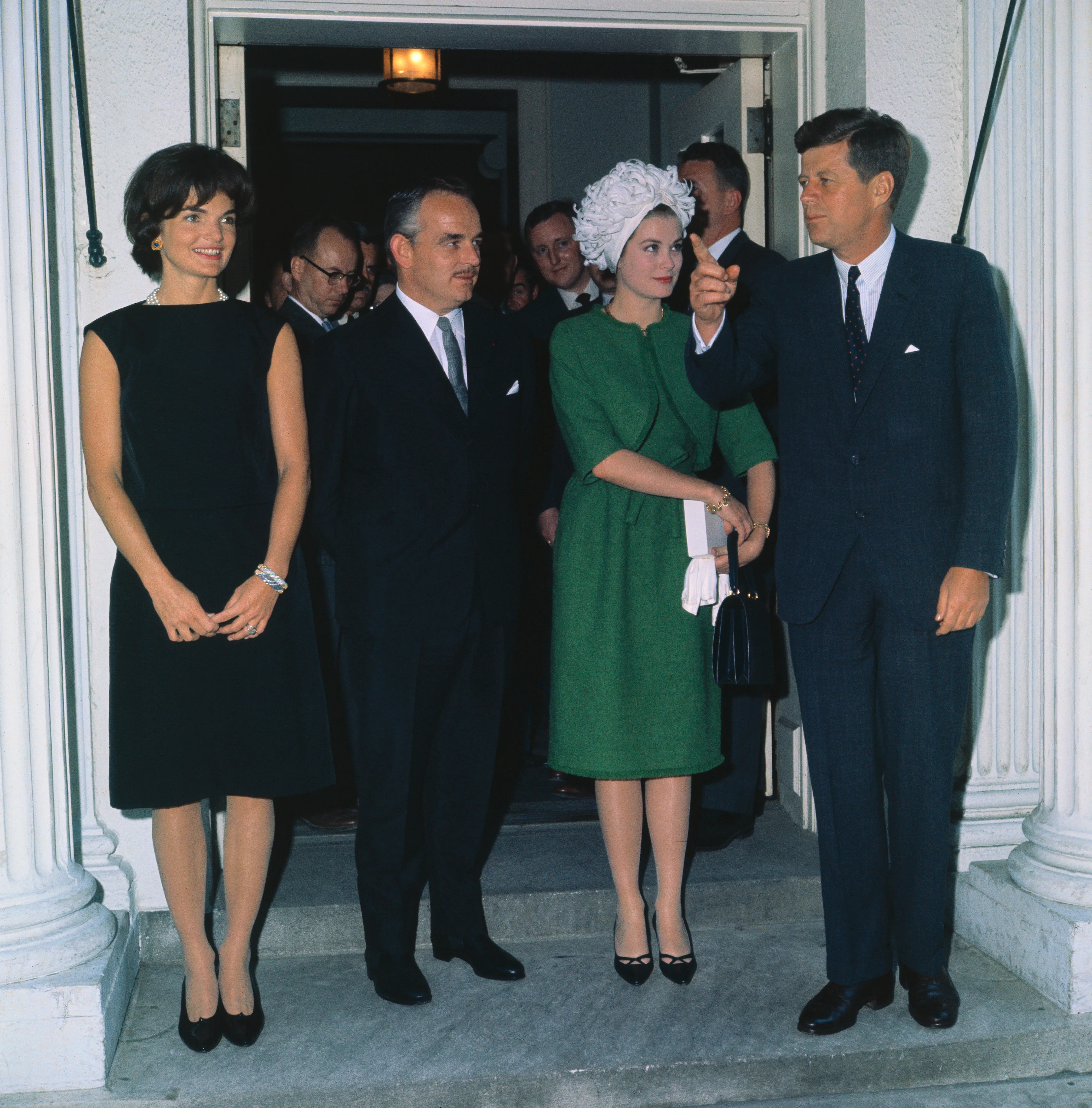 President and Mrs.. Kennedy pose with Prince Rainier and Princess Grace at a reception at the White House.