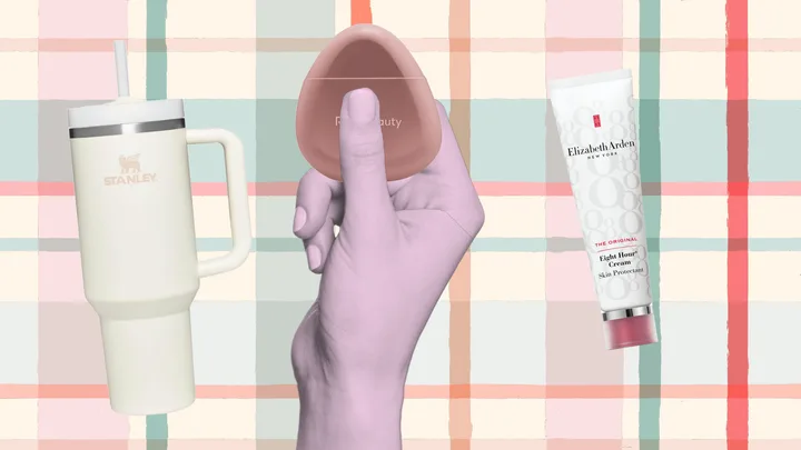 Stanley cup, Rare Beauty blush compact, and Elizabeth Arden cream tube on a plaid background.