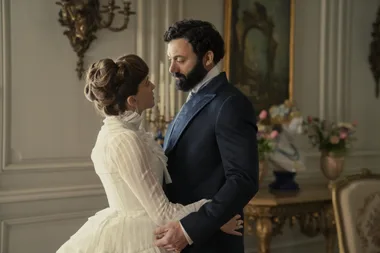A man and a woman in 1890s attire.