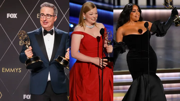Three people holding Emmy awards on stage in formal attire, each with a microphone.