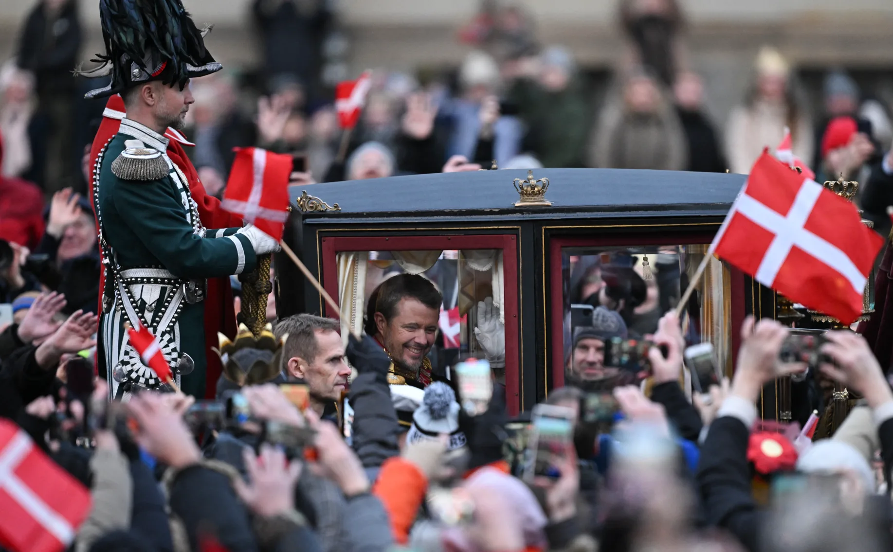 The crowd reacting to the new King and Queen of Denmark.