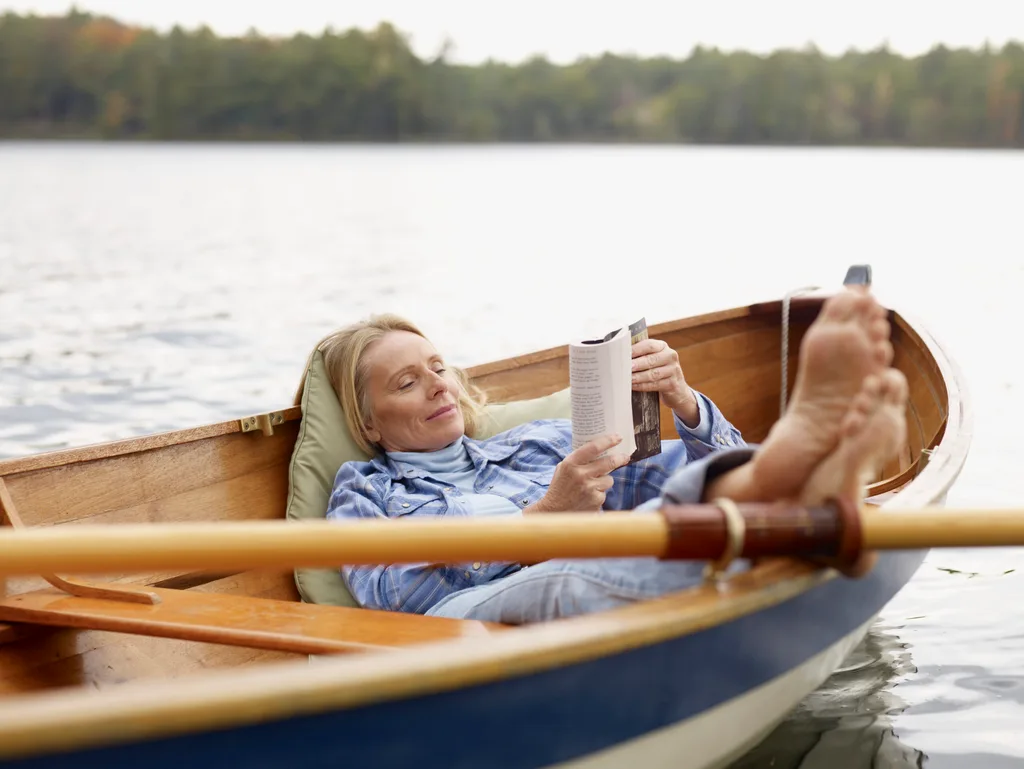 Woman reading a book in a boat