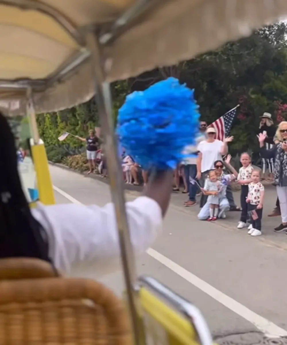 princess lilibet and meghan markle are among a group of people watching a 4th of July parade