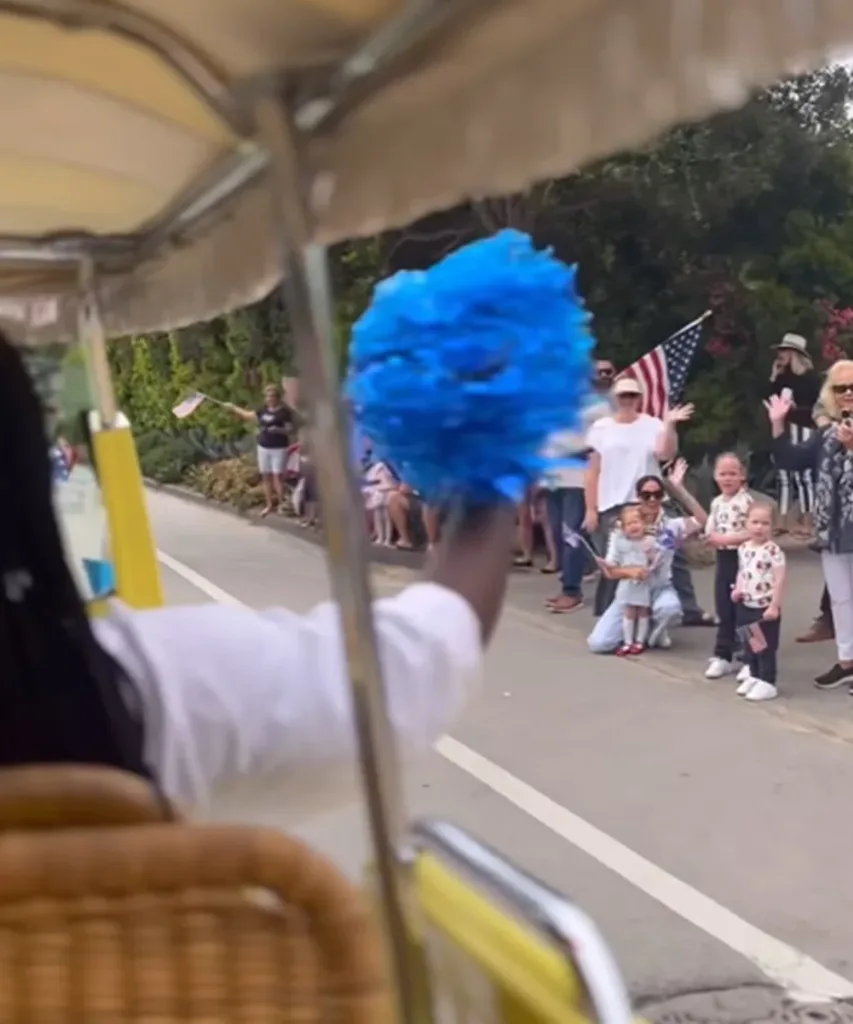 princess lilibet and meghan markle are among a group of people watching a 4th of July parade