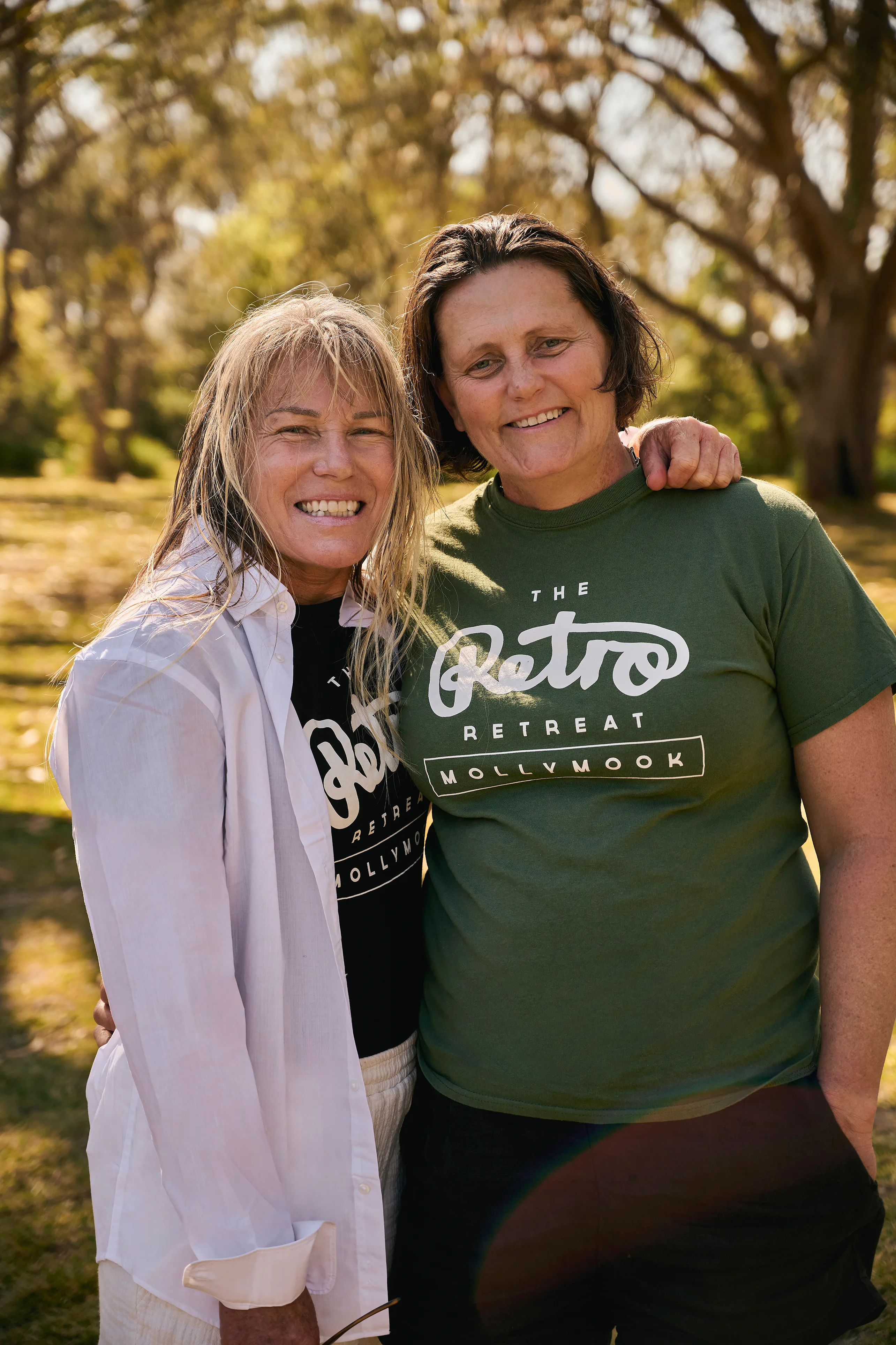 Australian female surfers Denise and Kristen smiling for a photo.