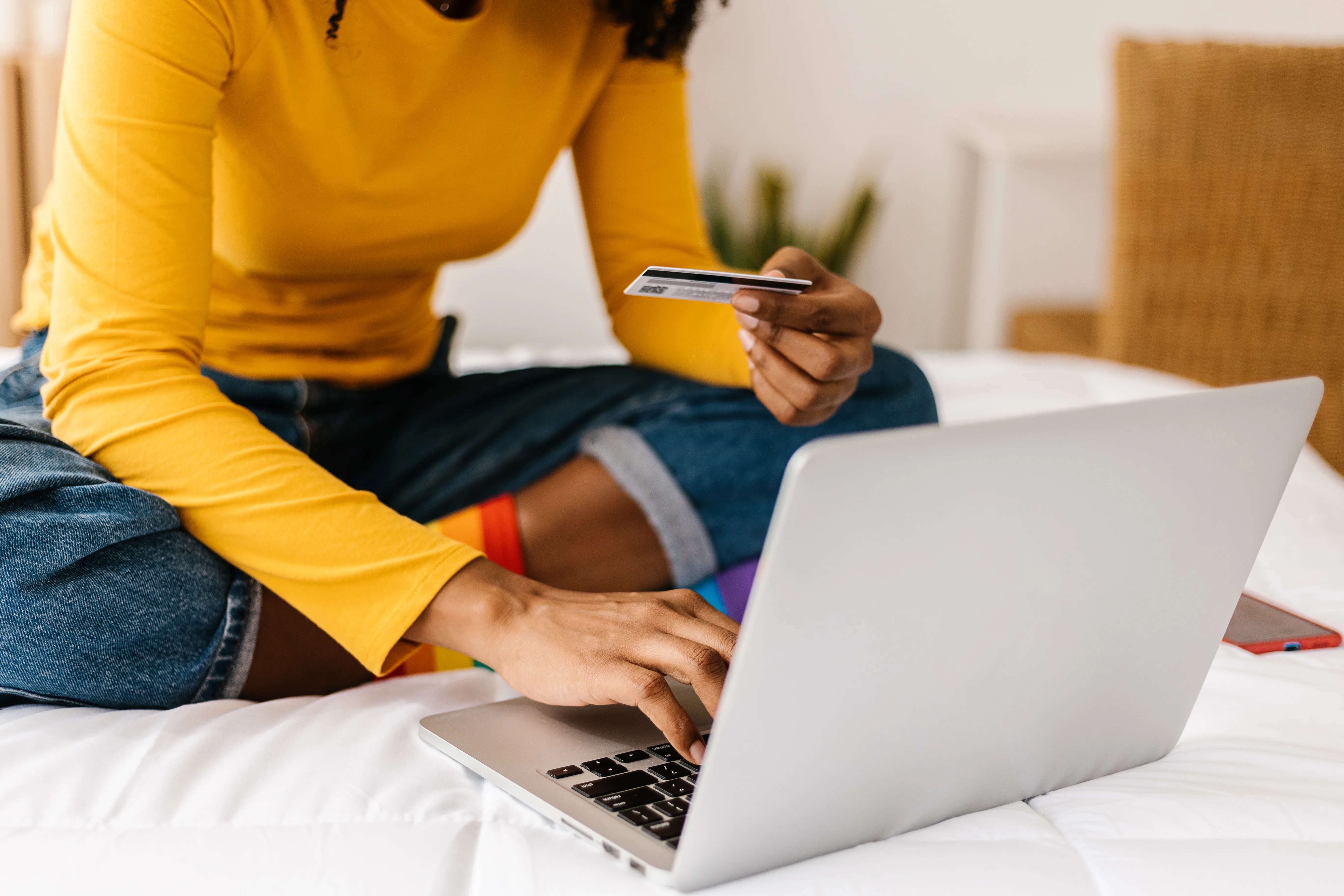 Getty: Close up woman hands using credit card to buy online on laptop - E-commerce and shopping online concept