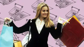 A scene from the movie Clueless, featuring Alicia Silverstone as Cher Horowitz. She is dressed in a chic black blazer and white blouse, holding multiple shopping bags with a confident smile. The background features a pink design with shopping cart illustrations.