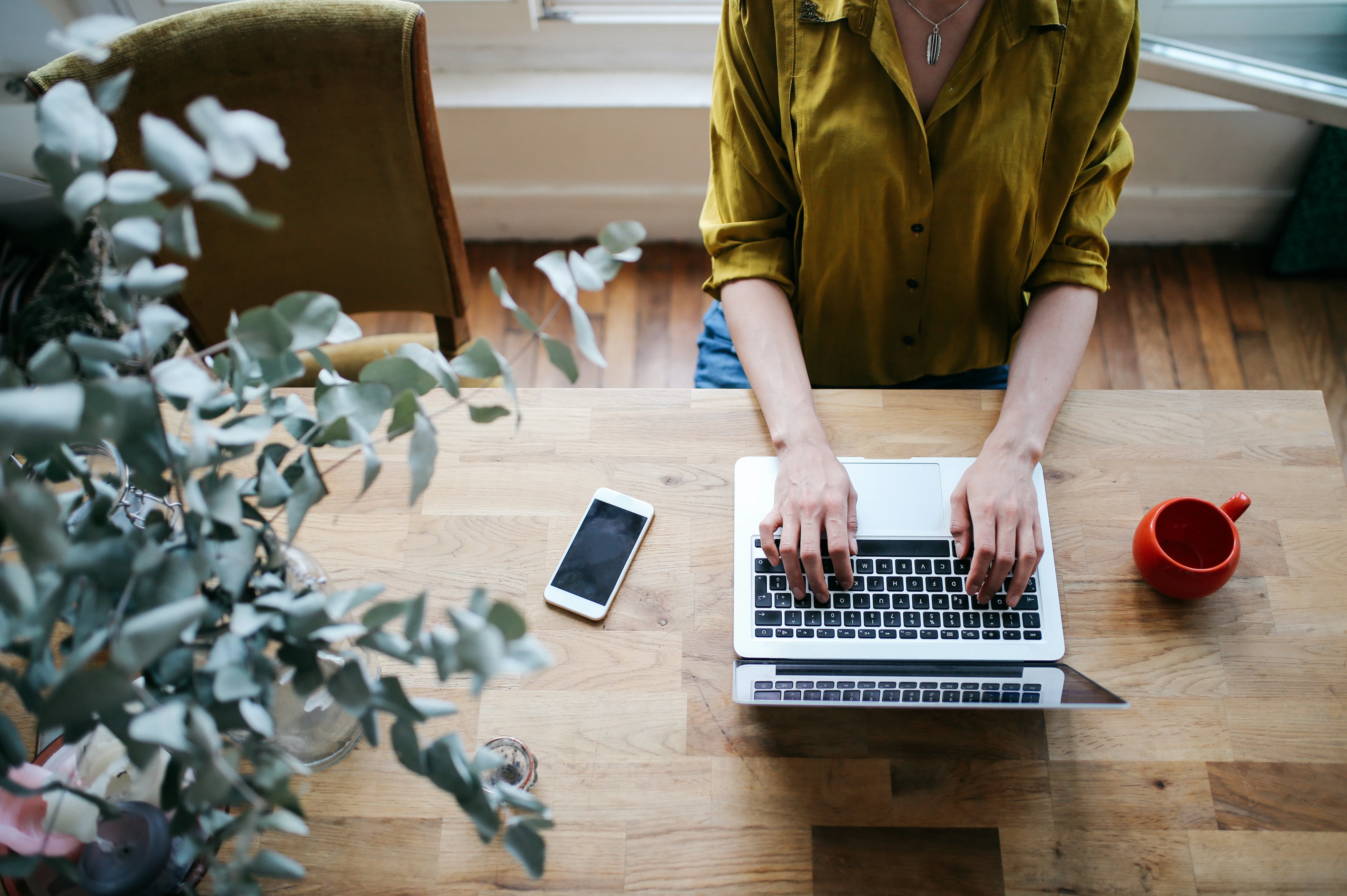 Stock image of woman at desk on her laptop computer.