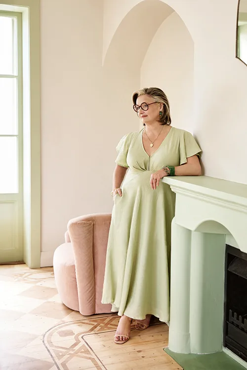 Julie Goodwin standing at fireplace