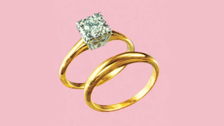 Two gold rings, one with a diamond, on a pink background.