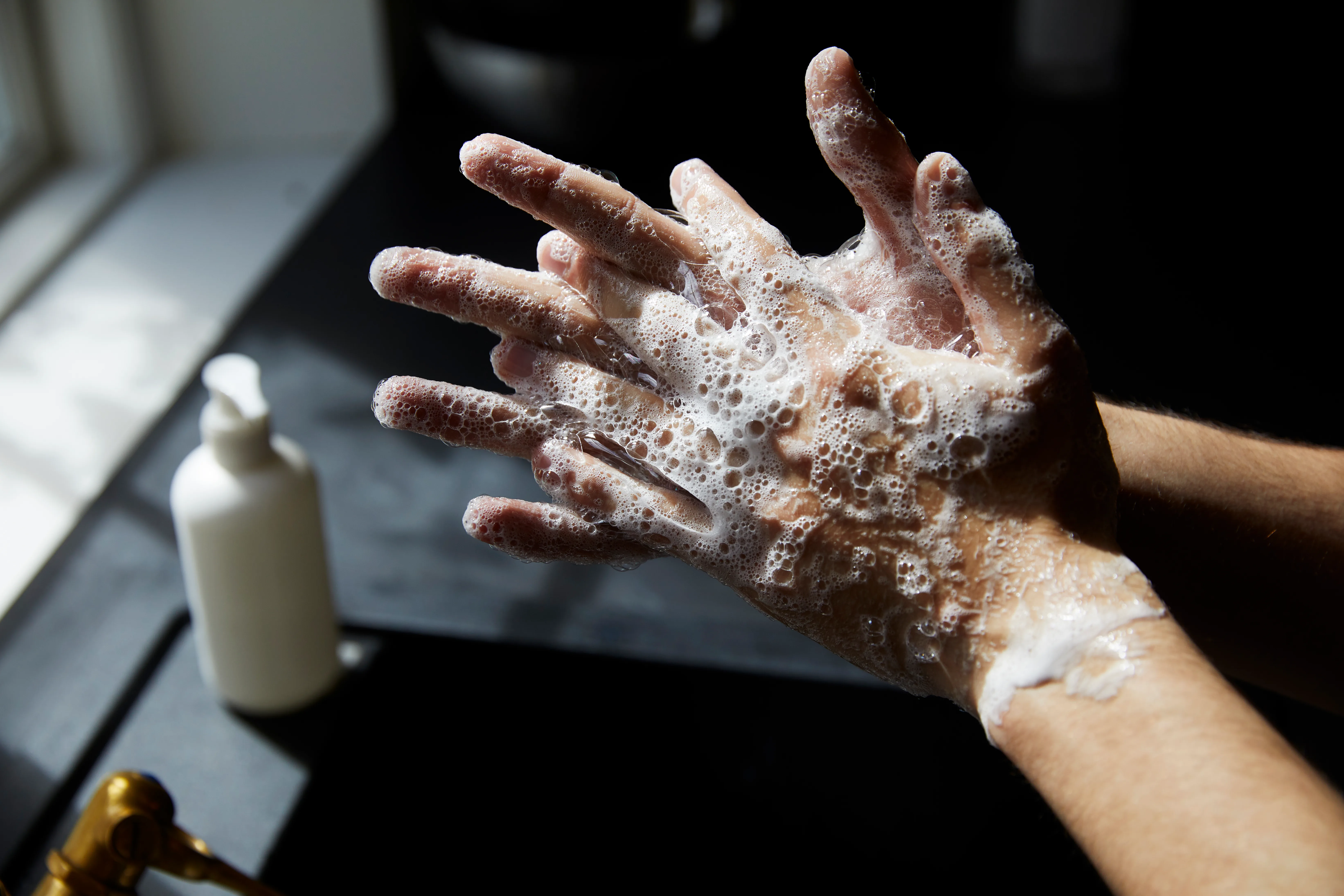 Young person washing hands to avoid a cold