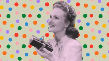 A retro-style woman smiling, holding a wrapped gift, against a colorful polka dot background.