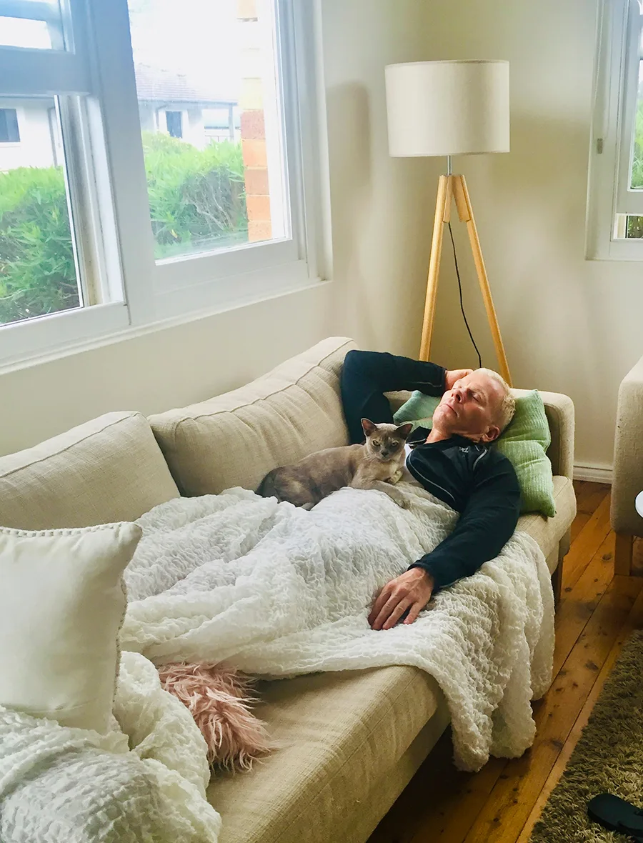 Hamish McLaren asleep with Tracy's cat. 