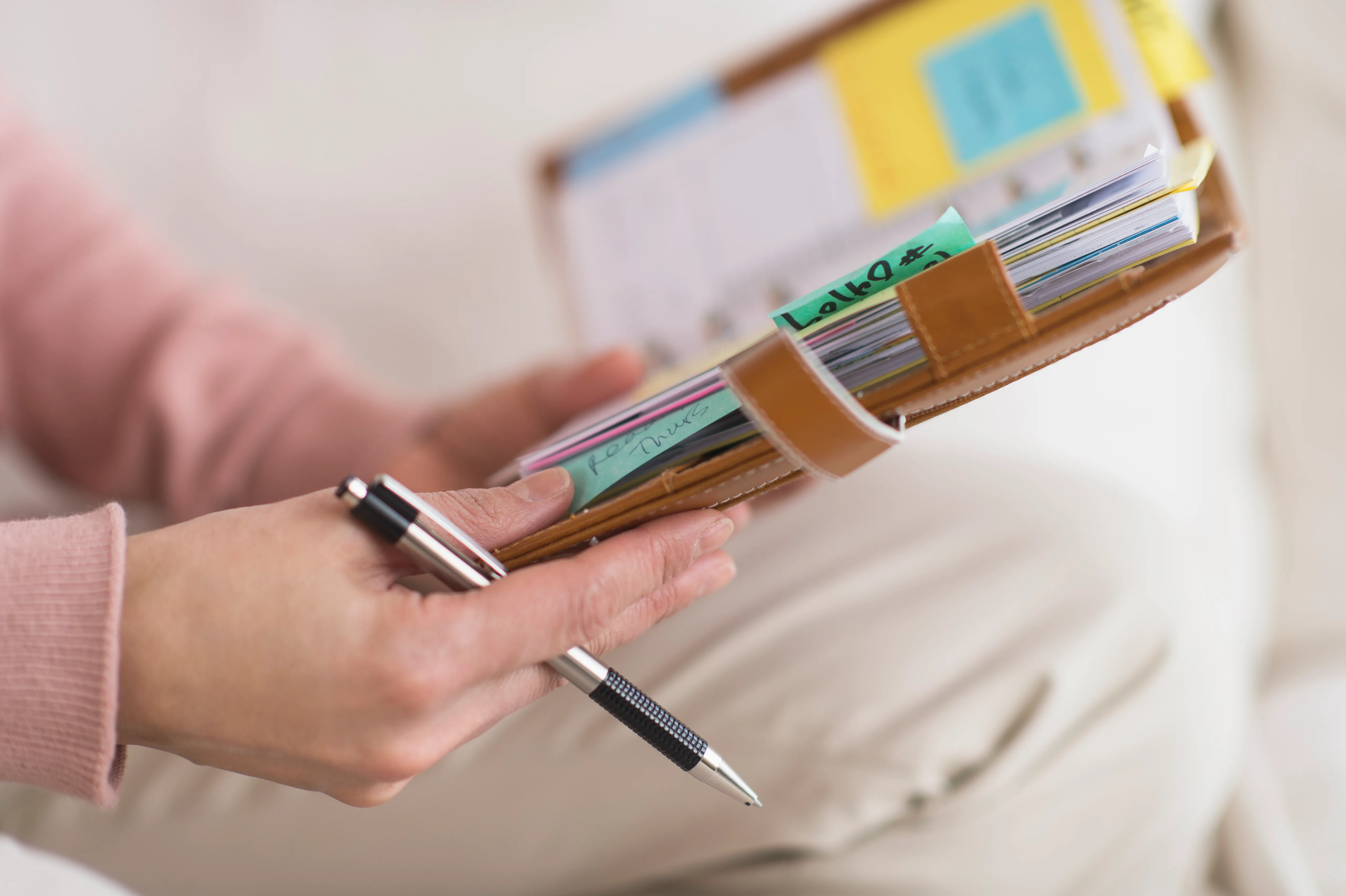 A woman going through her daily planner. 