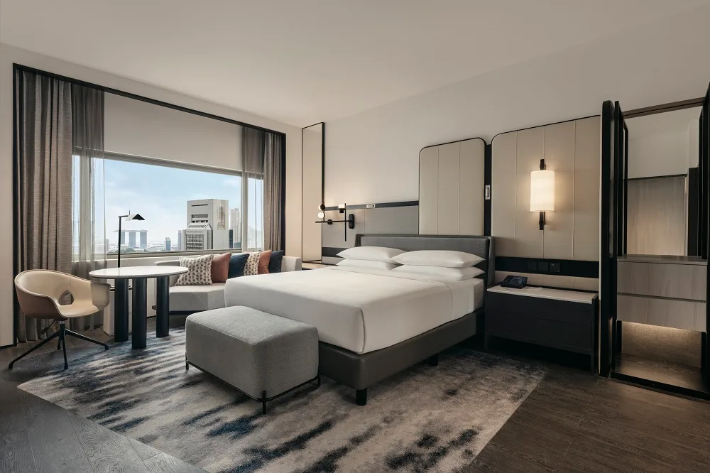 A room at the Hilton Singapore Orchard with a view looking out towards Marina Bay Sands. 