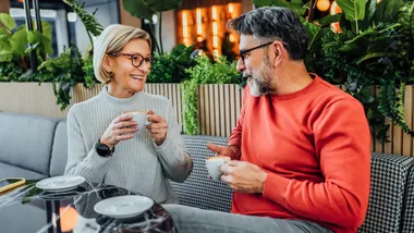 A happy couple at a cafe, enjoying retirement.